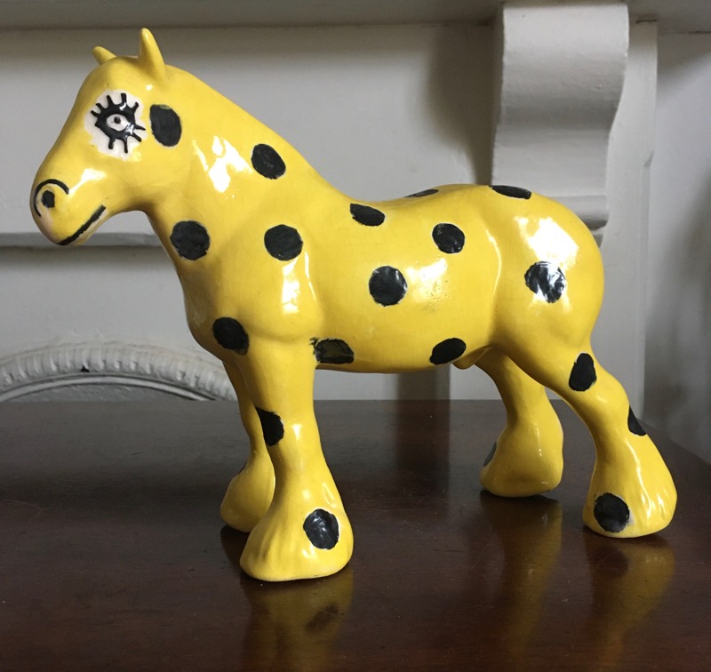 Ceramic yellow model horse with black spots
