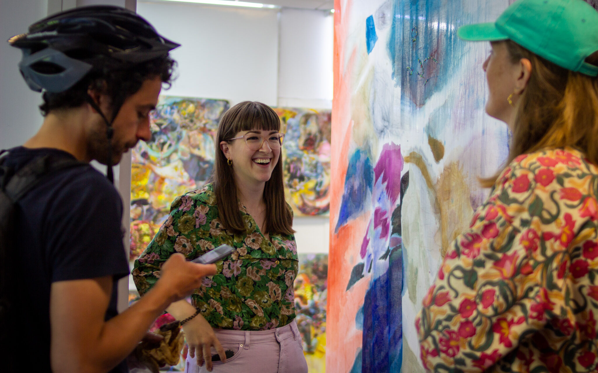 Artist Ellie Shipman talking in studio surrounded by artwork